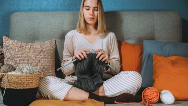 Girl knitting at home