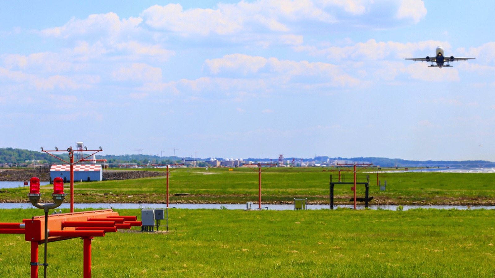 WASHINGTON DC, USA - MAY 3, 2015: An airplane departing from Ronald Reagan National Airport seen from Gravelly Point Park.