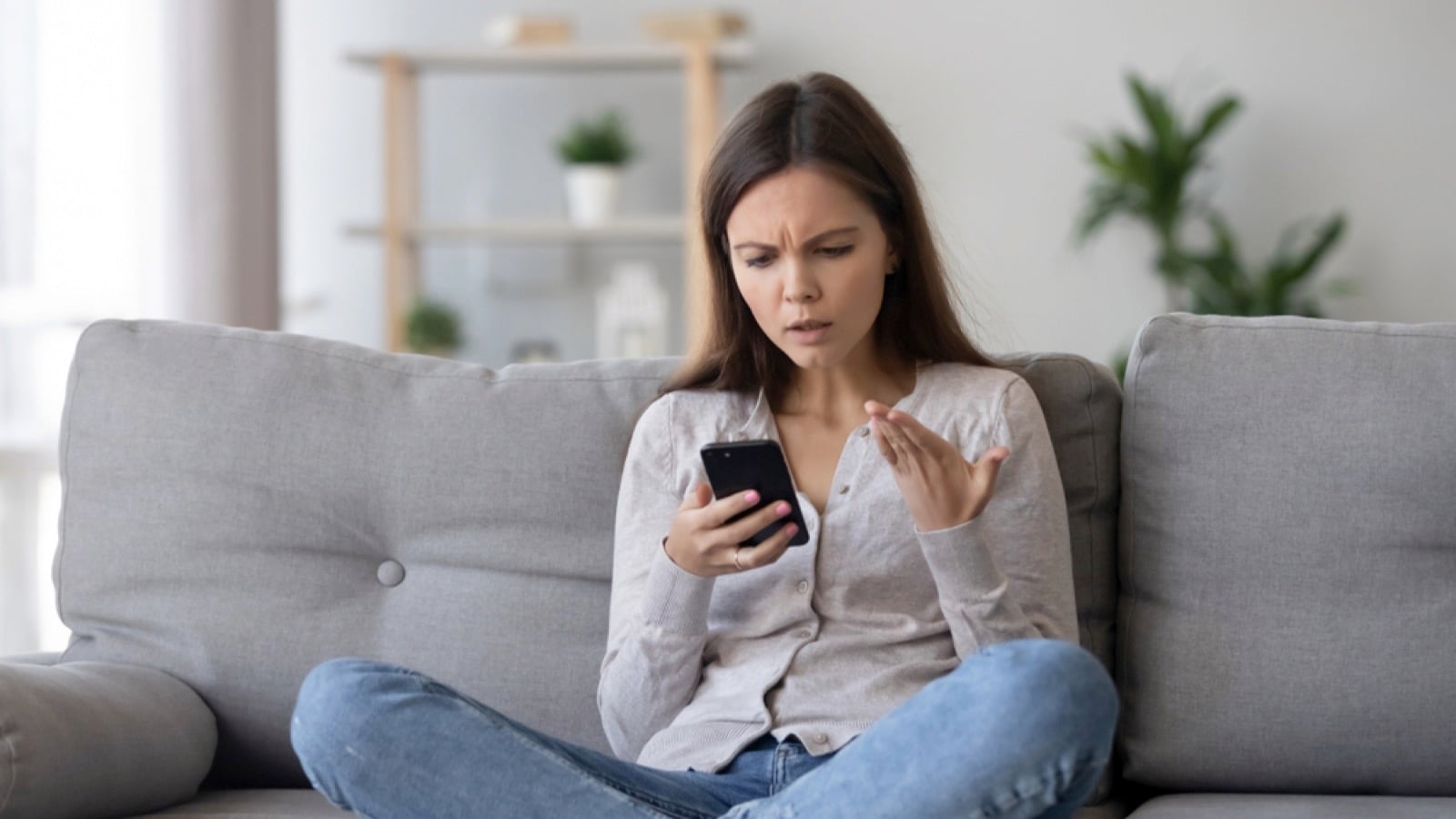 Irritated young woman with mobile