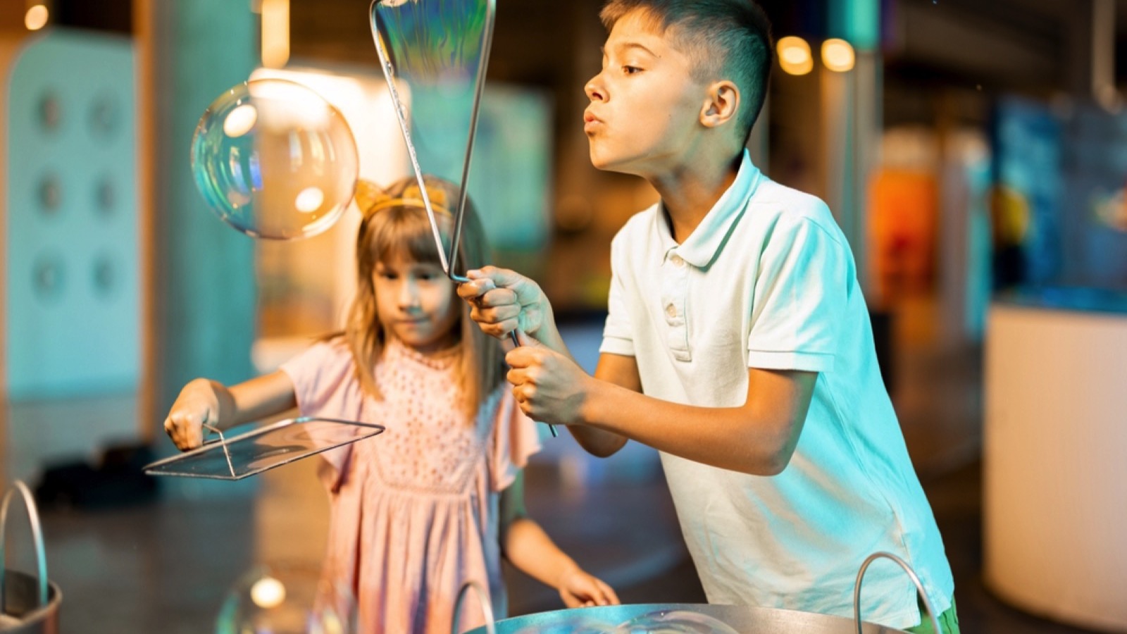 Little boy and girl makes soap bubbles