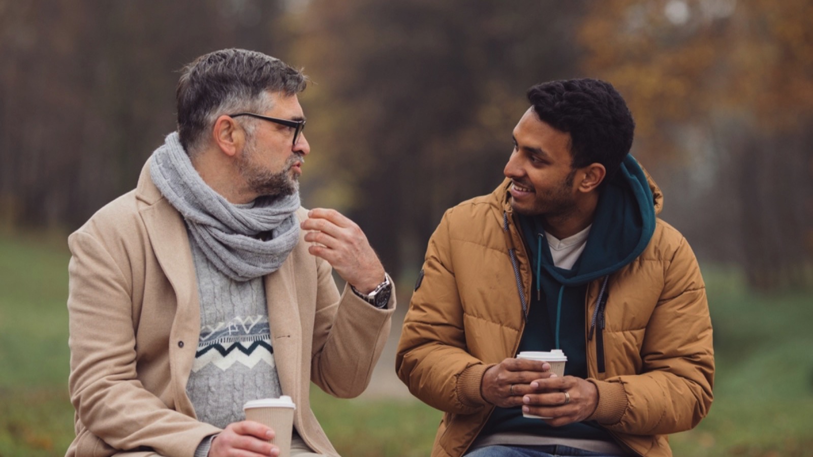 Man talking to friend with coffee