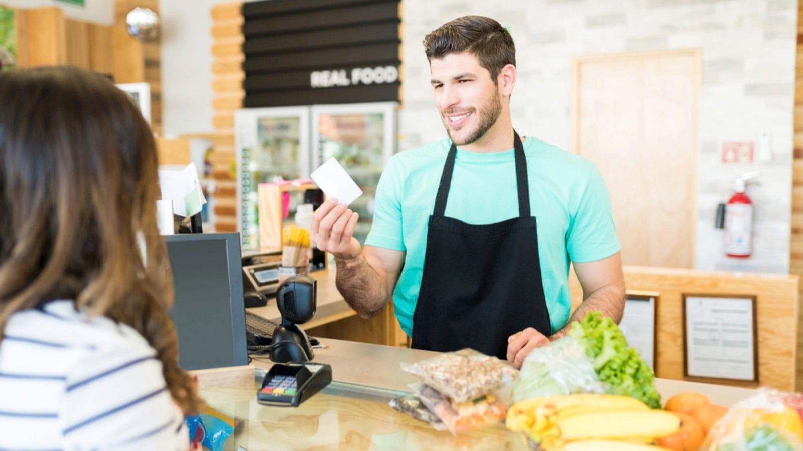 Owner giving reward card to customer