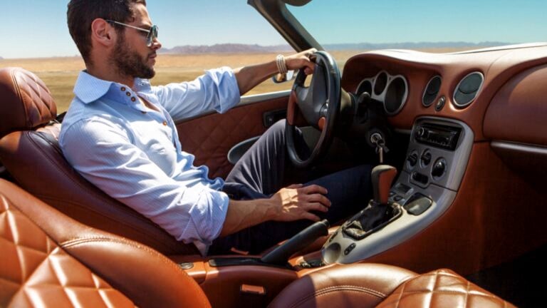 Rich man driving luxury car