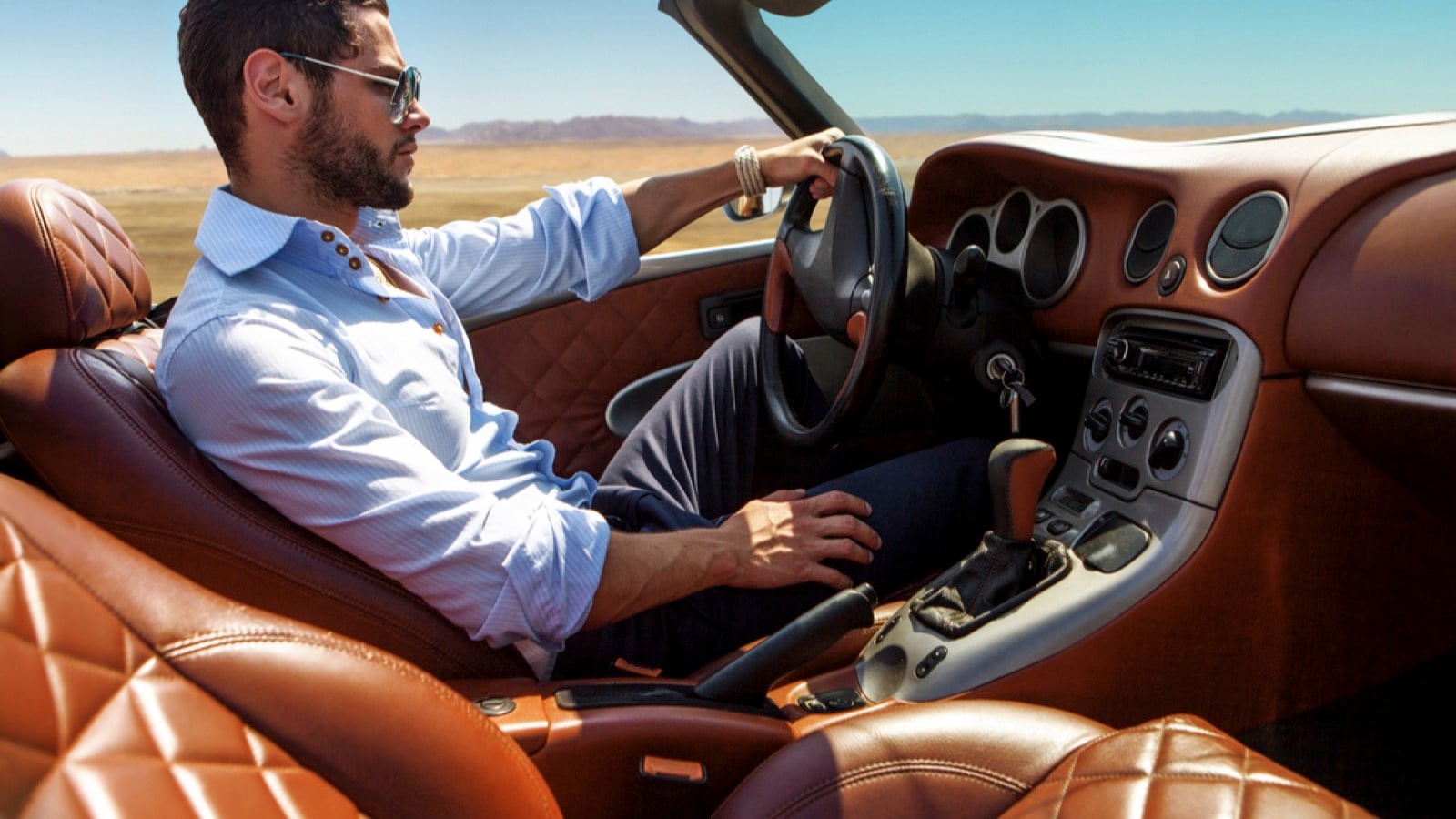 Rich man driving luxury car