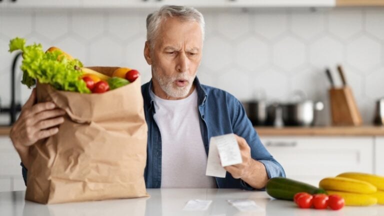 Senior man checking grocery bill