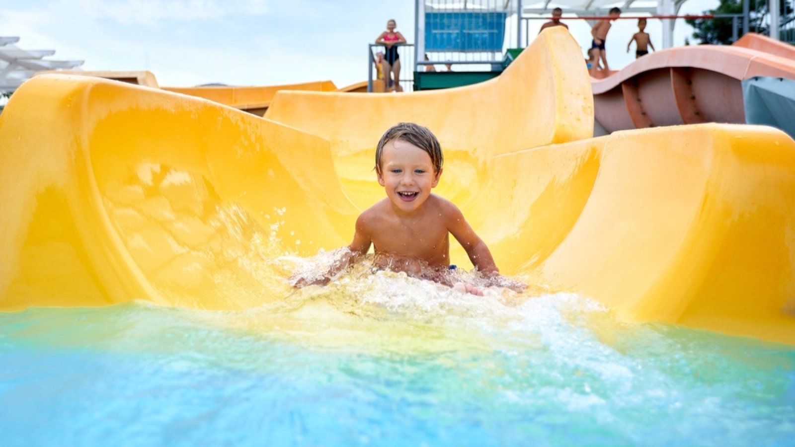 Small boy playing in water rides