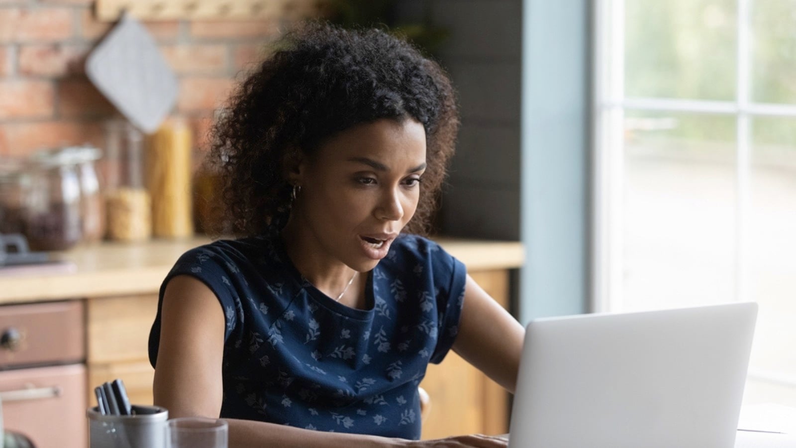 Stressed african woman in online appointment