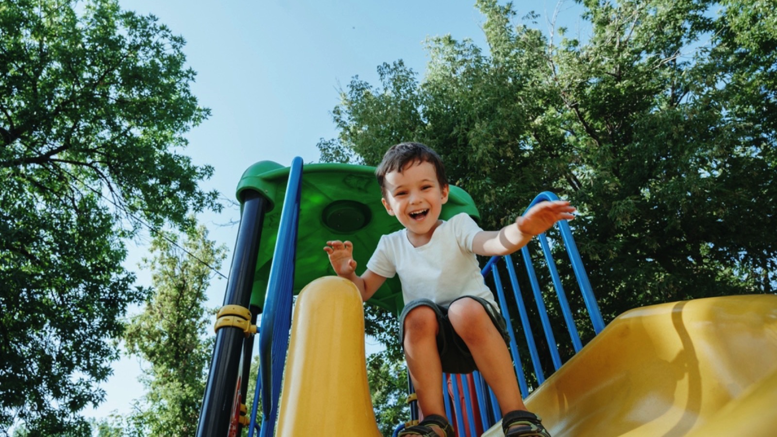 Toddle playing in slide