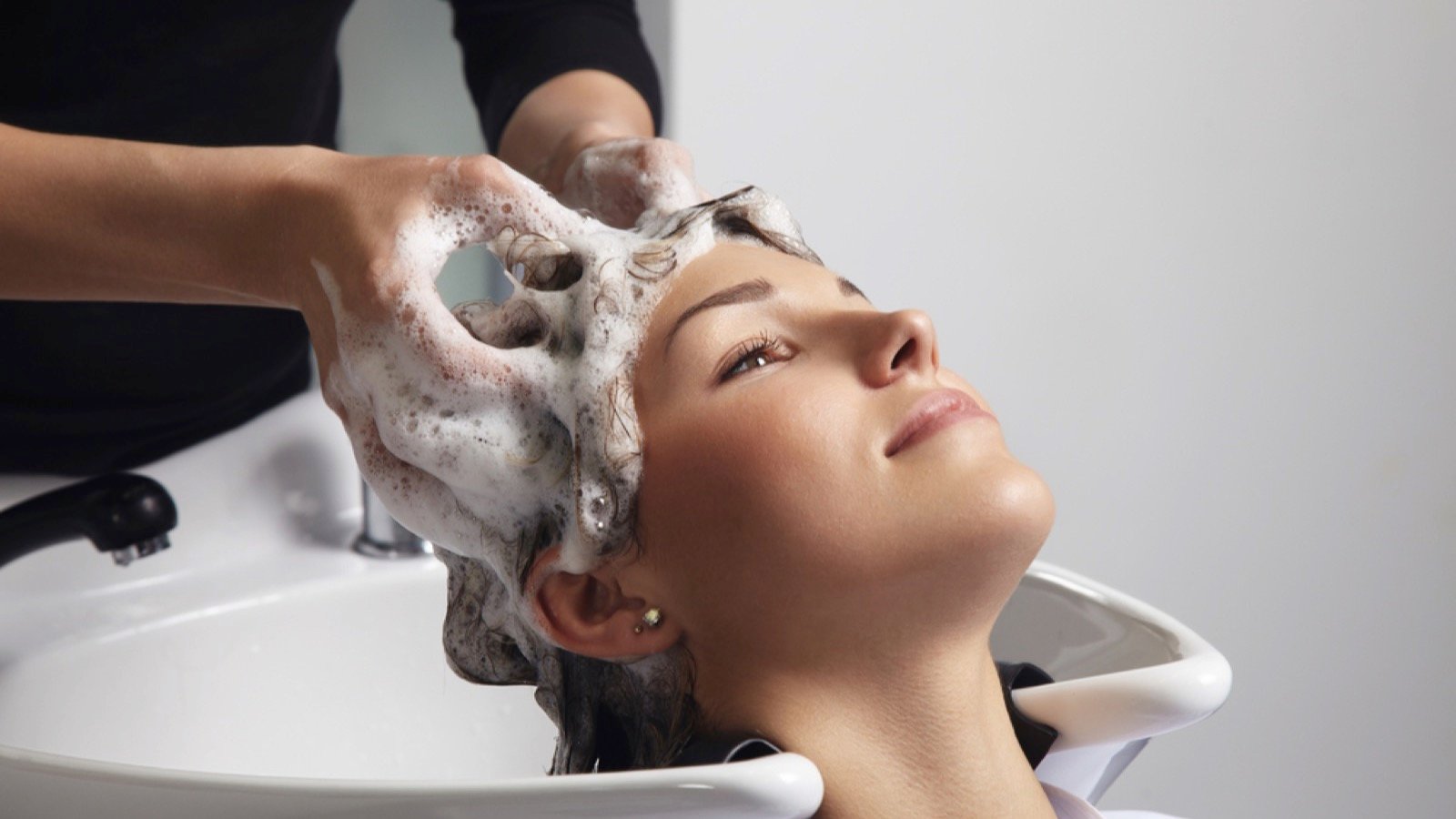 Woman doing hair spa in salon