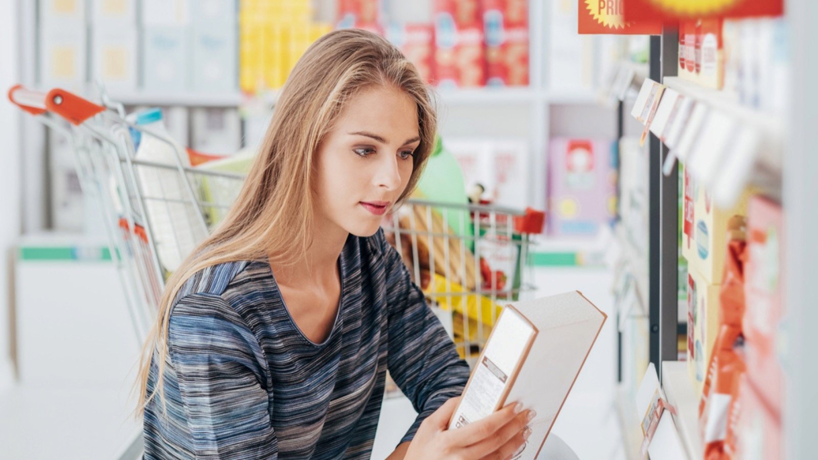 Woman taking grocery from lower shelf