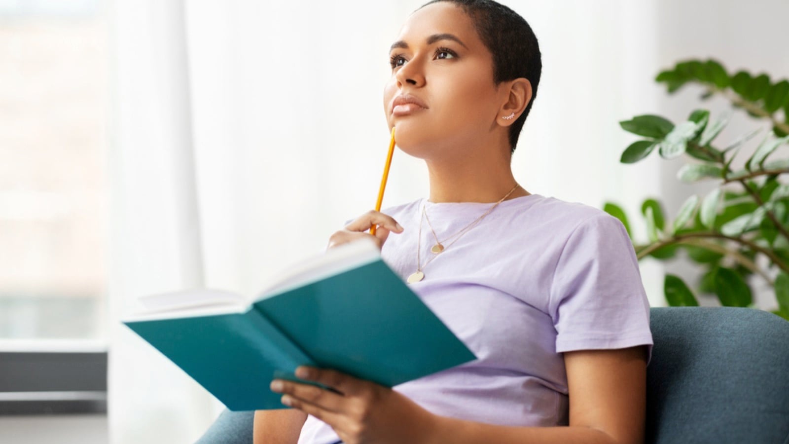 Woman thinking and writing