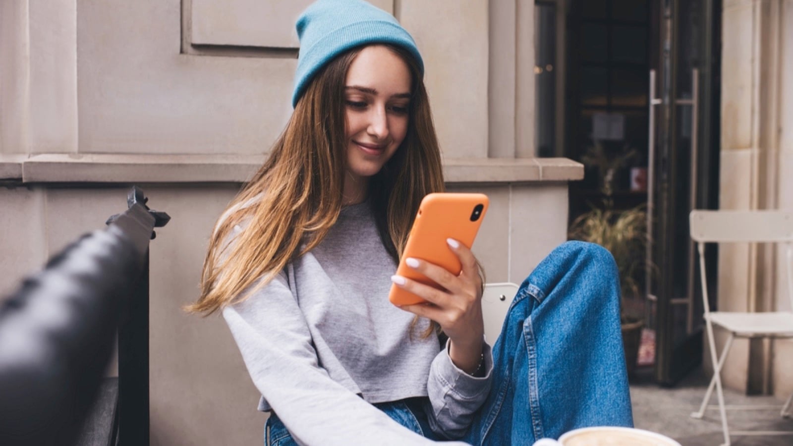 Woman using orange color phone case
