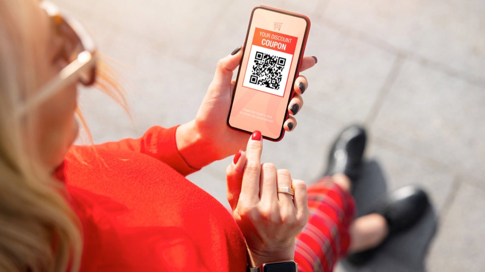 Woman viewing discount coupon on mobile