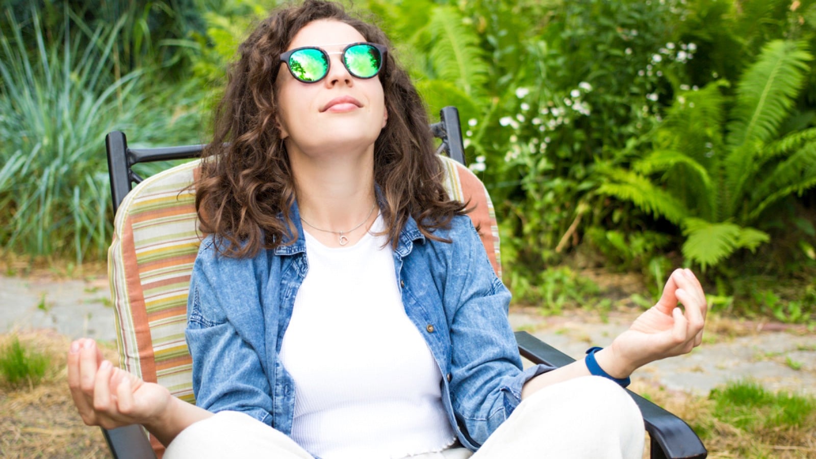 Woman with sunglasses doing meditation