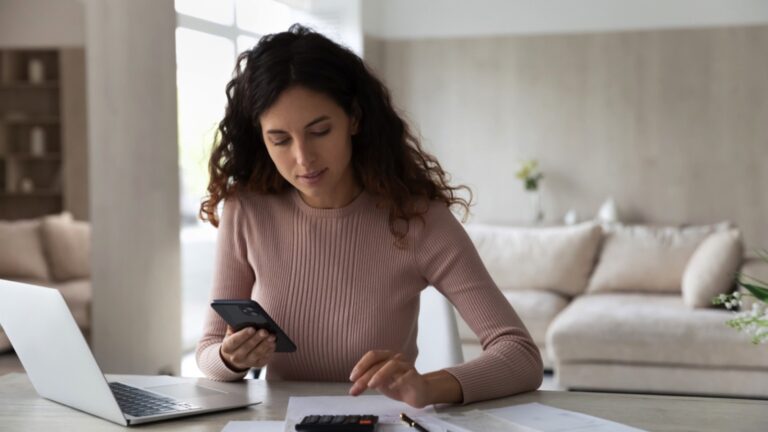 Young woman calculating expense