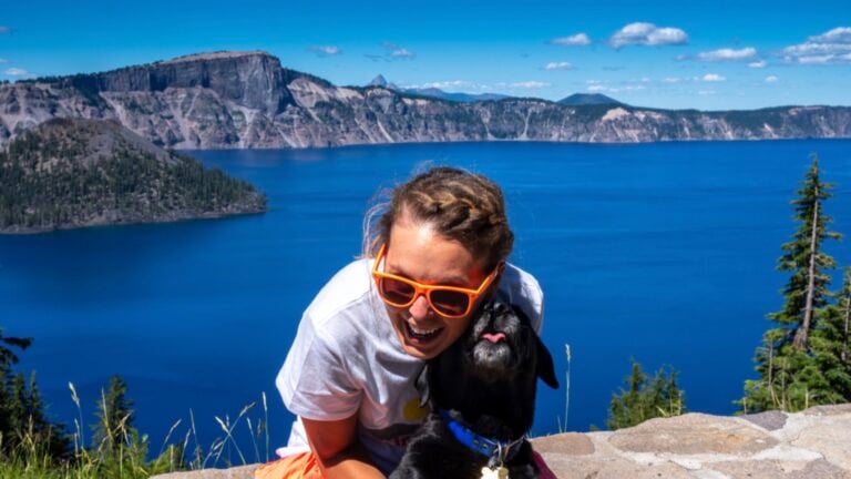 Happy woman tourist enjoys Crater Lake National Park