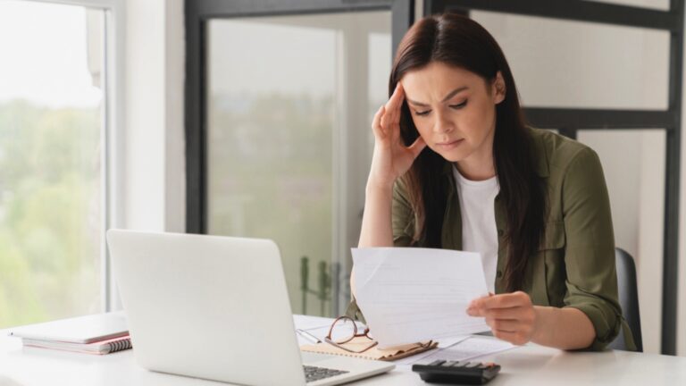 Woman checking utility bill and upset