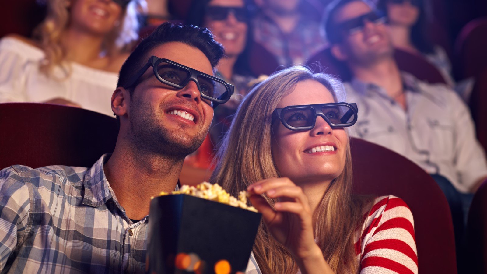 Happy,Couple,Sitting,In,Movie,Theater,,Watching,3d,Movie,,Eating