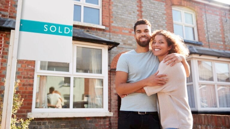 Couples infront of their new house