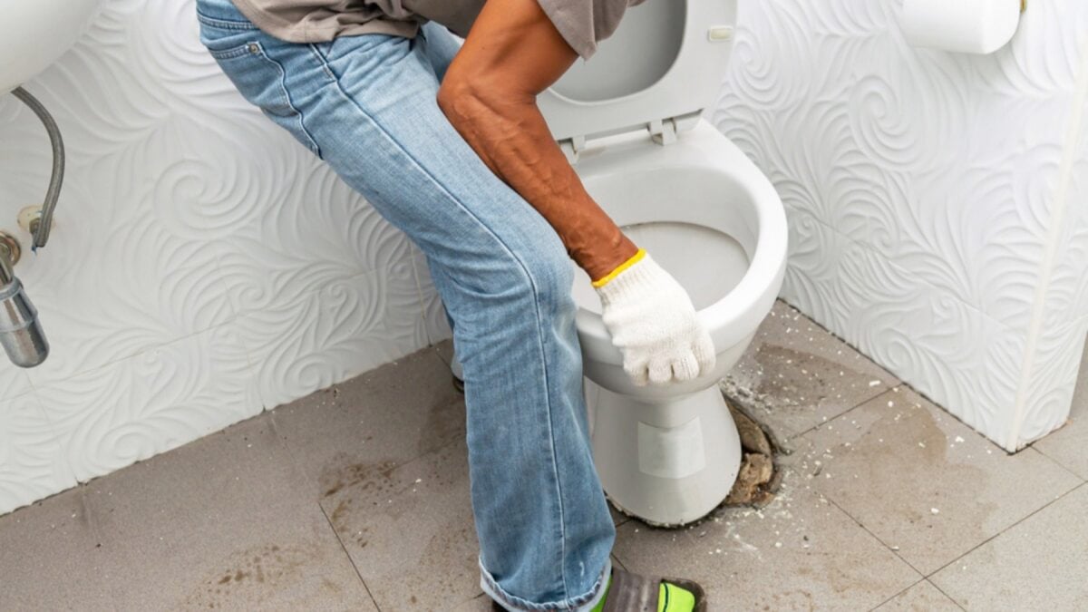 Man repairing toilet