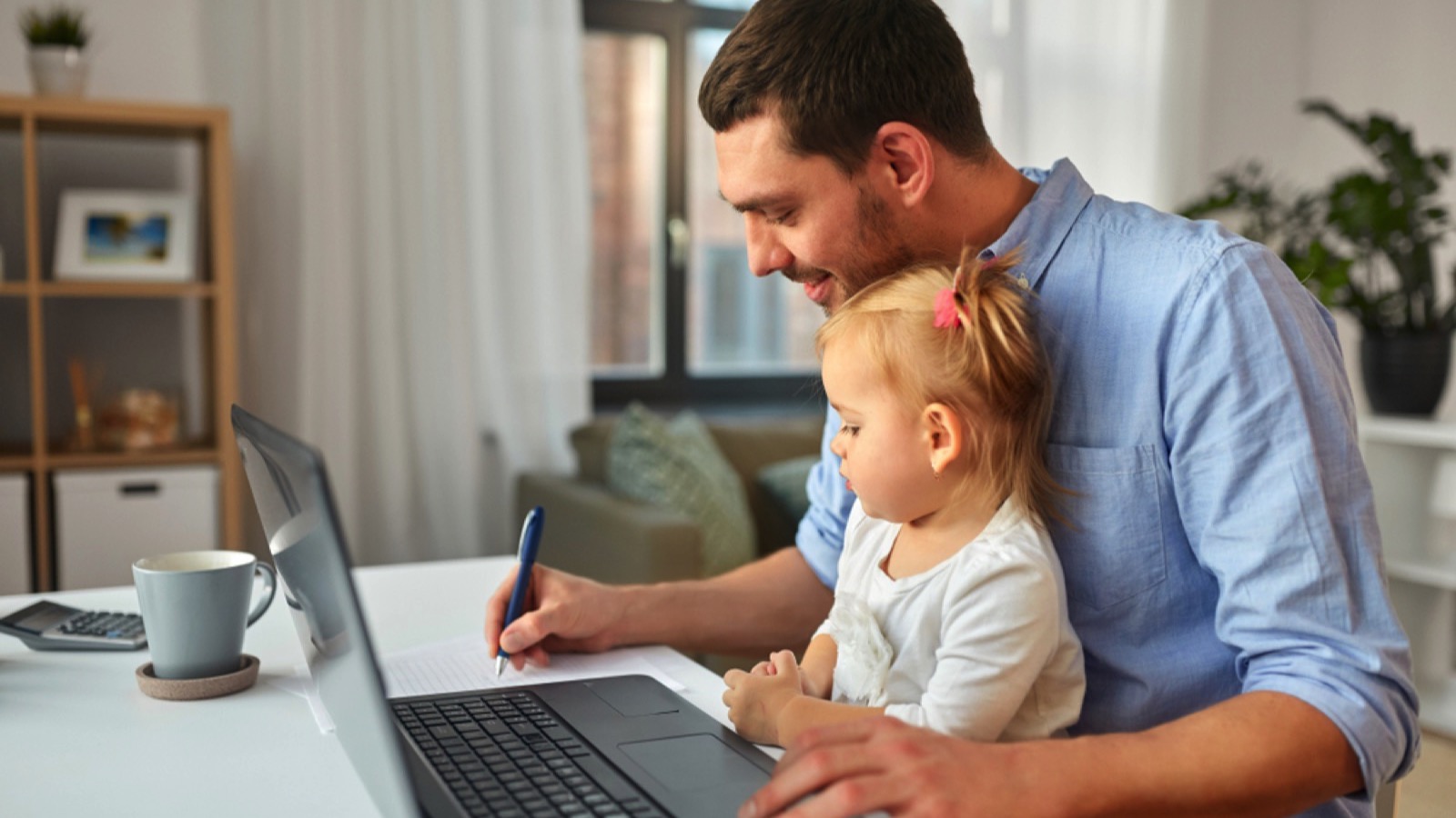 Man working with baby in lap