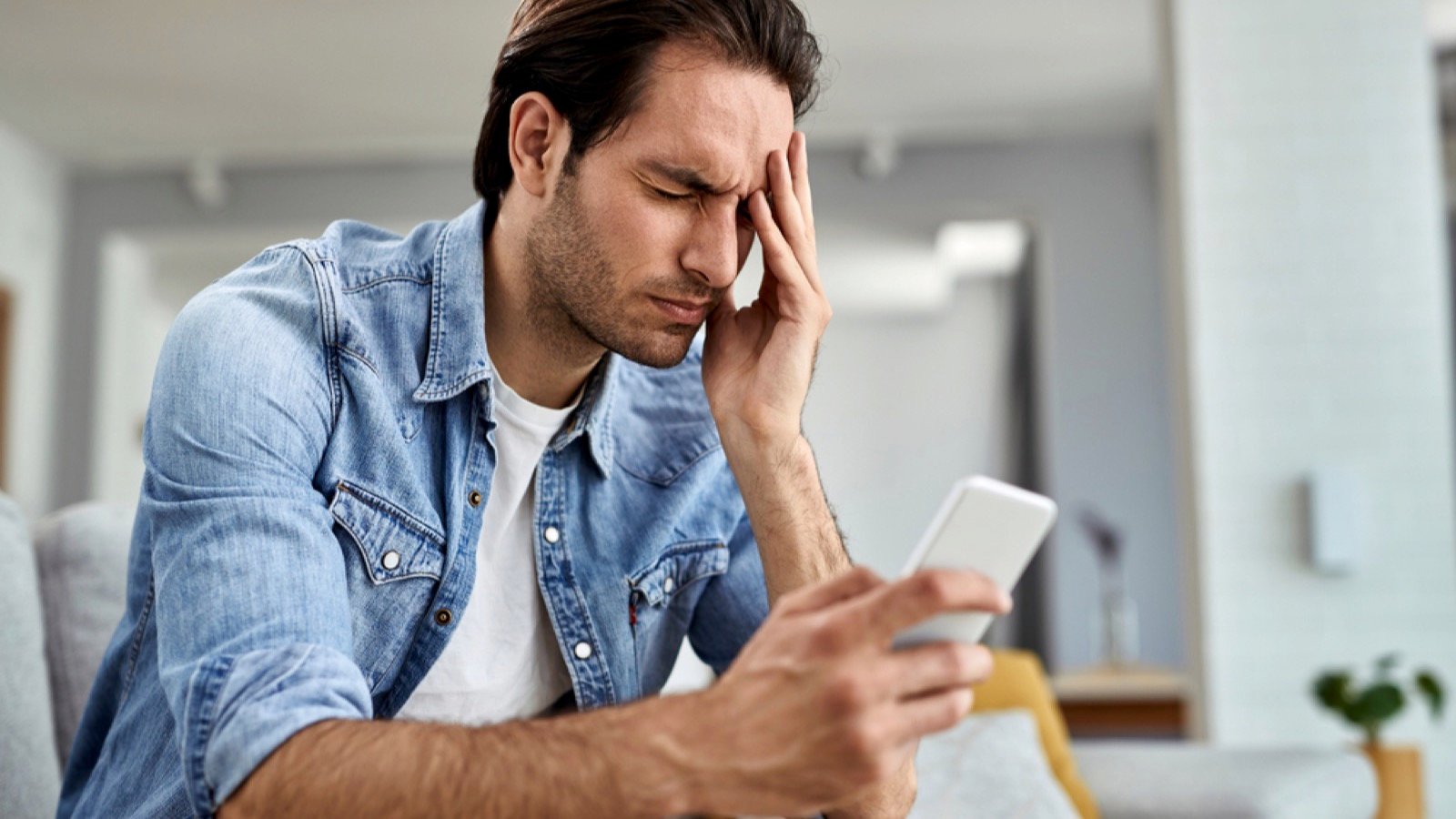 Stressed man using mobile to track