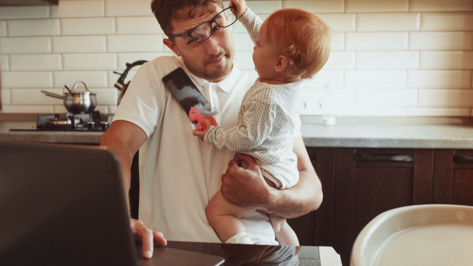 Stressed man working with his baby