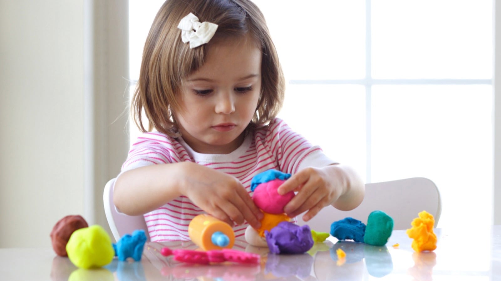 Kid playing with play dough