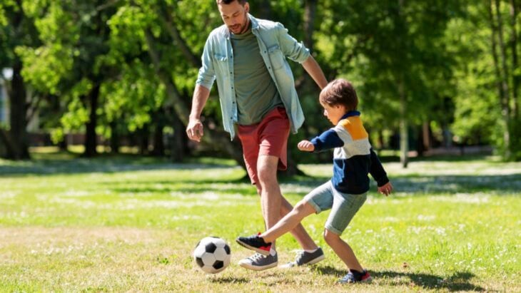 Man playing football with his son
