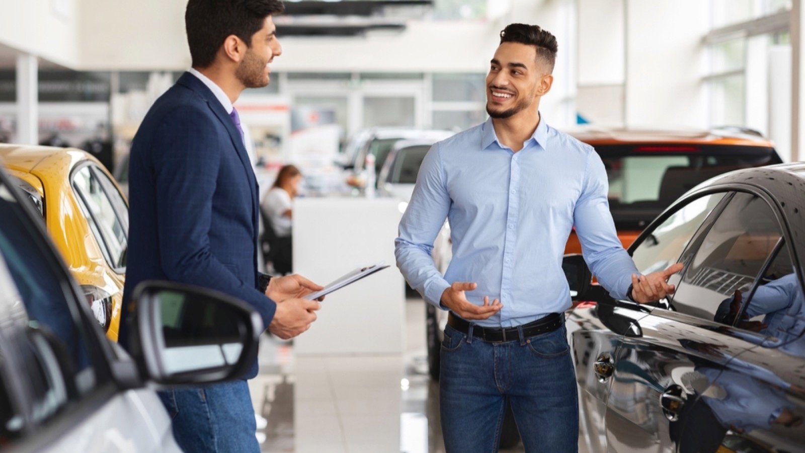 Man talking to car dealer