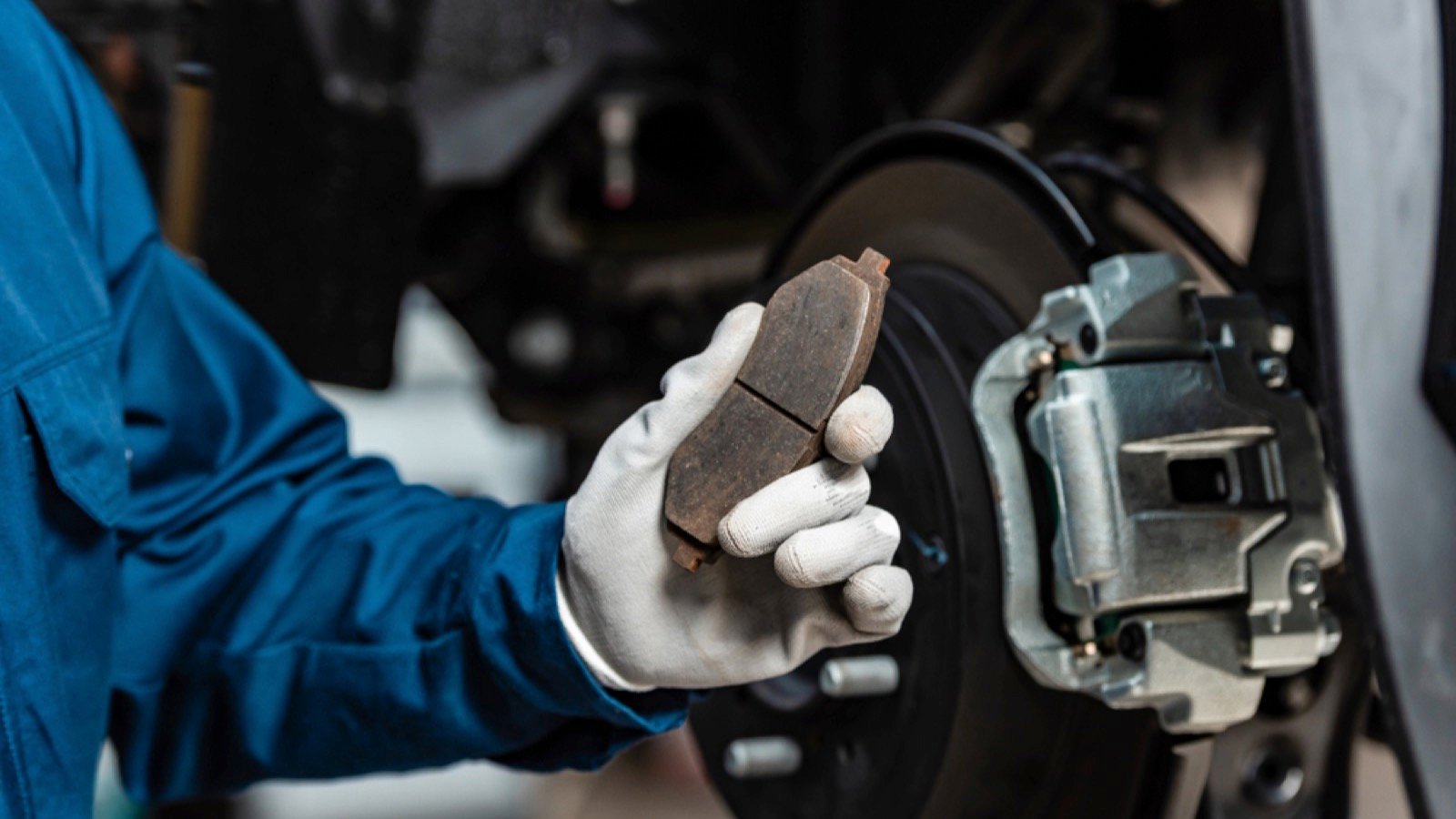 Mechanic holding brake pad