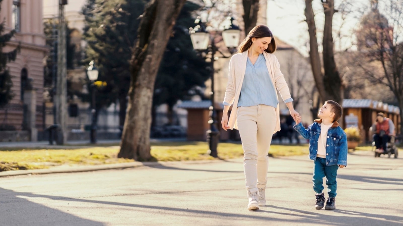 Mother walking with toddler in park