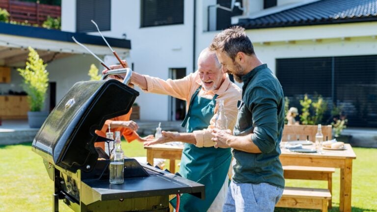 Father and son in the garden admiring barbecue