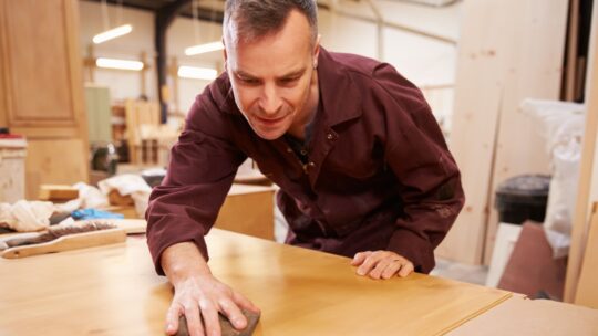 Carpenter putting the finishing touches to his work