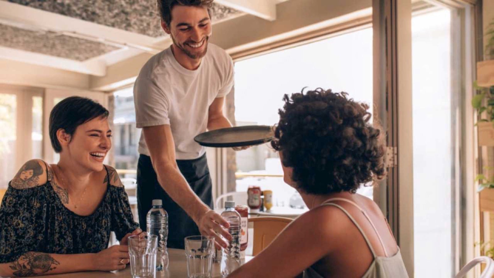Waiter serving water bottle