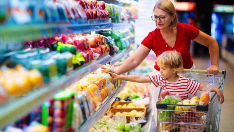 Woman buying grocery with kid