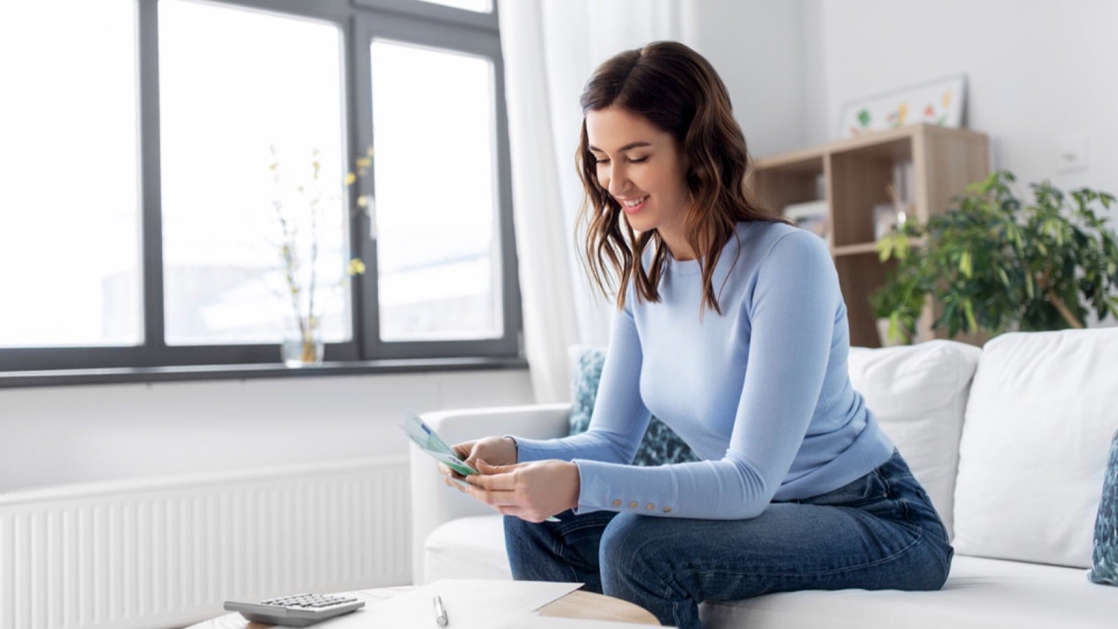 Woman counting money for bills
