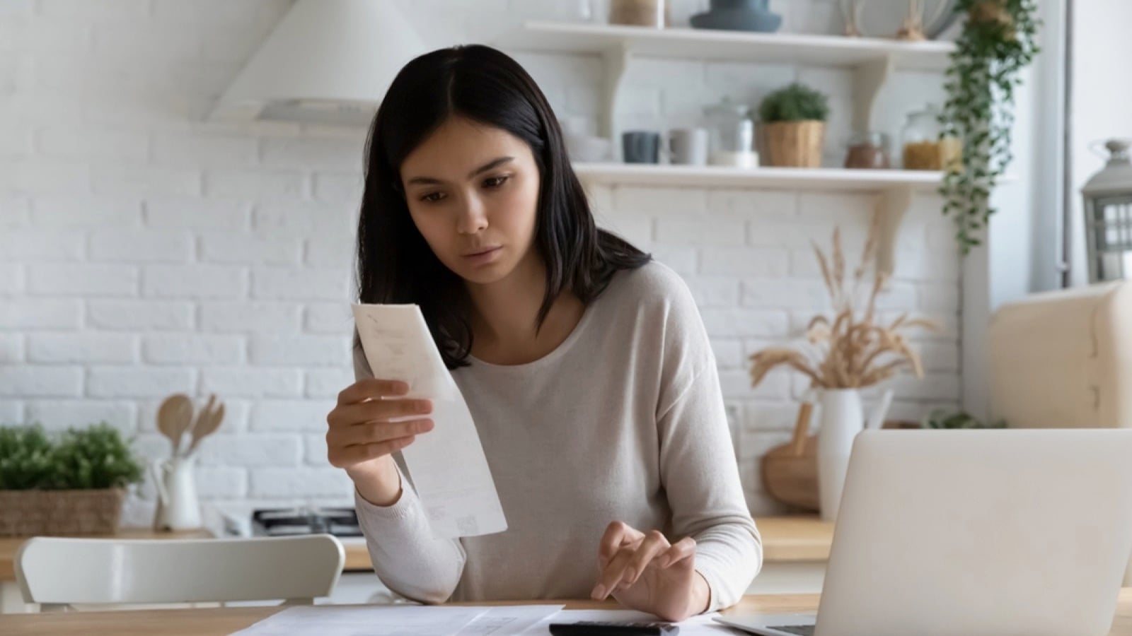 Woman looking at bills for debt