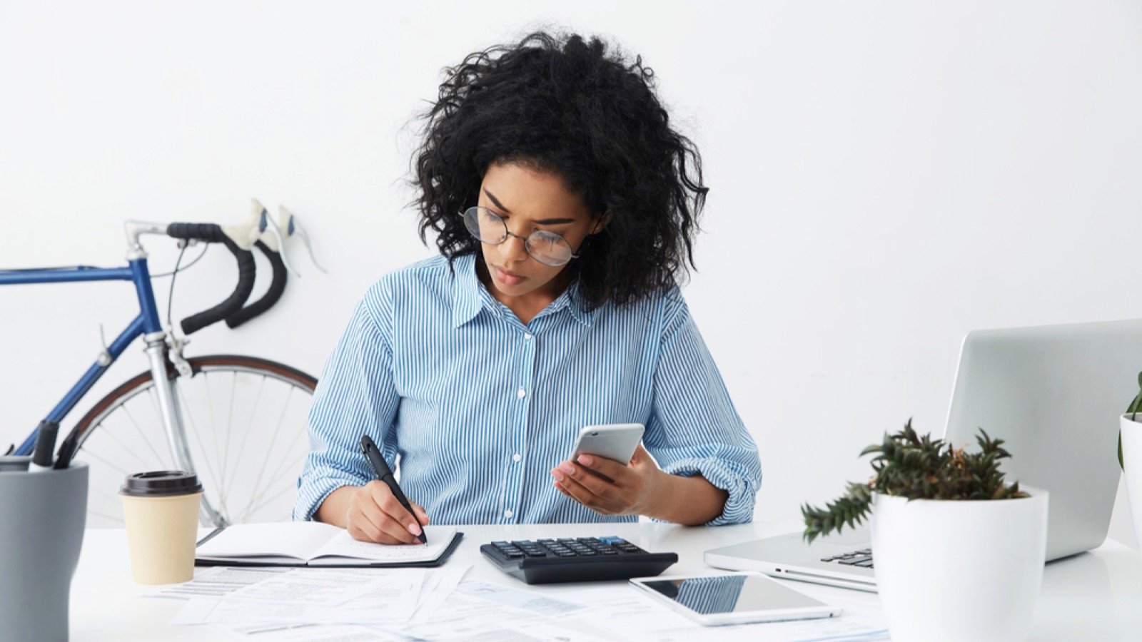 Young woman writing budget and bill