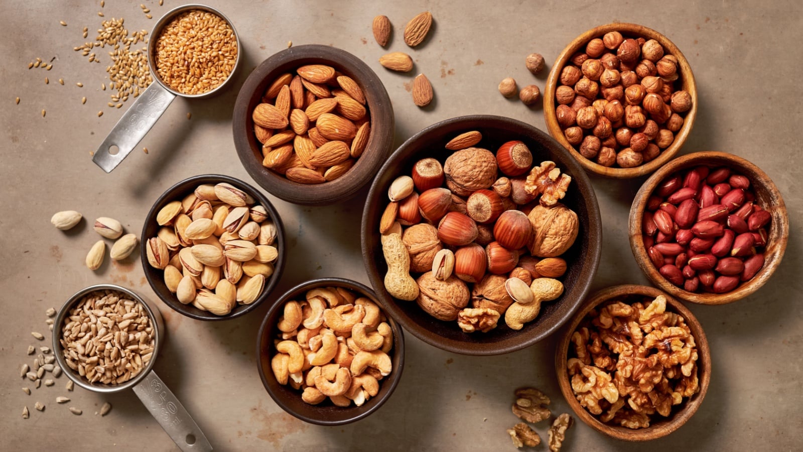 Assortment of nuts and seeds in small bowls