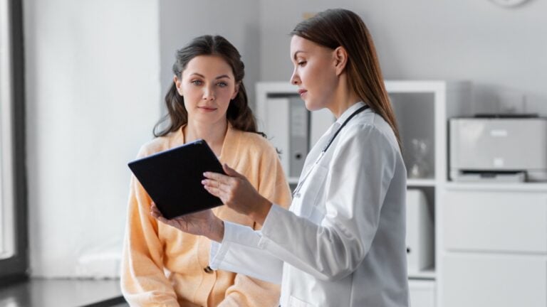 Doctors appointment discussing treatment & insurance costs