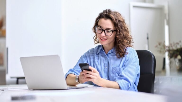 Woman using laptop and mobile for banking