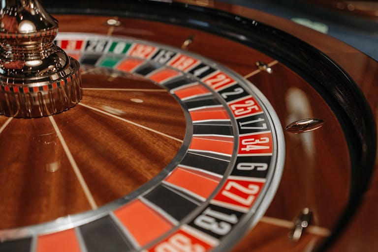 Investing and Gambling Close-up of an elegant roulette wheel showcasing numbers and colors, ideal for casino themes.