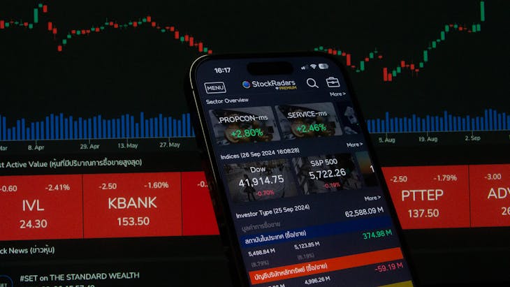 Wealth Management in 2026 Close-up of a digital stock trading app interface with investment charts and market trends displayed.