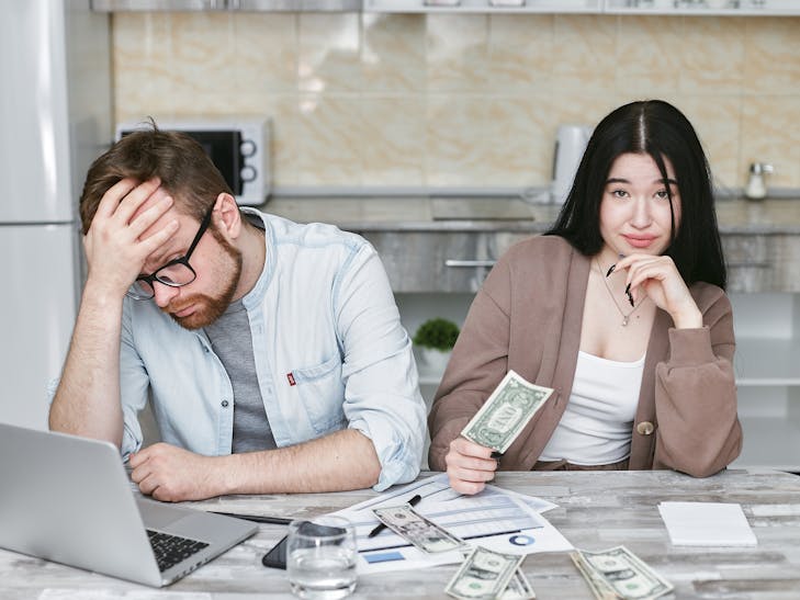 Financial Infidelity A couple managing their finances in a kitchen setting, showcasing money, debt, and budgeting challenges.