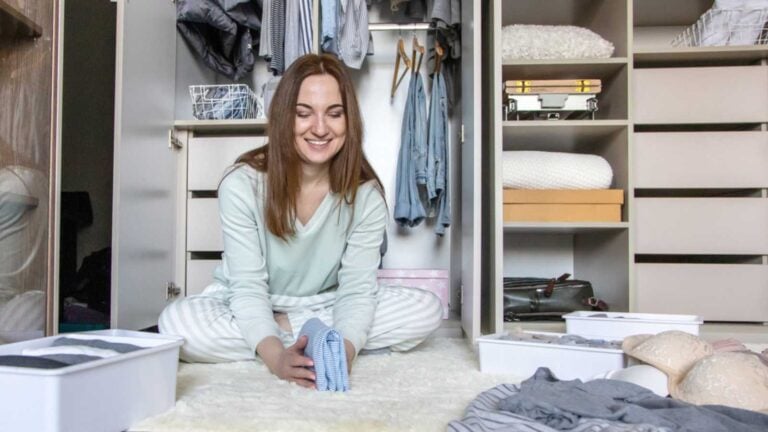 Spring Clean Woman decluttering wardrobe.