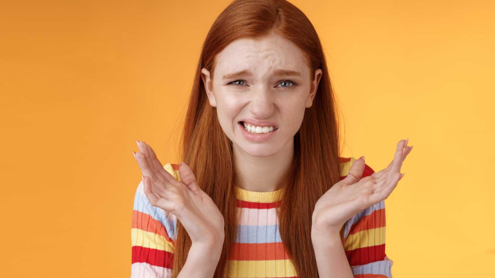 Woman cringing