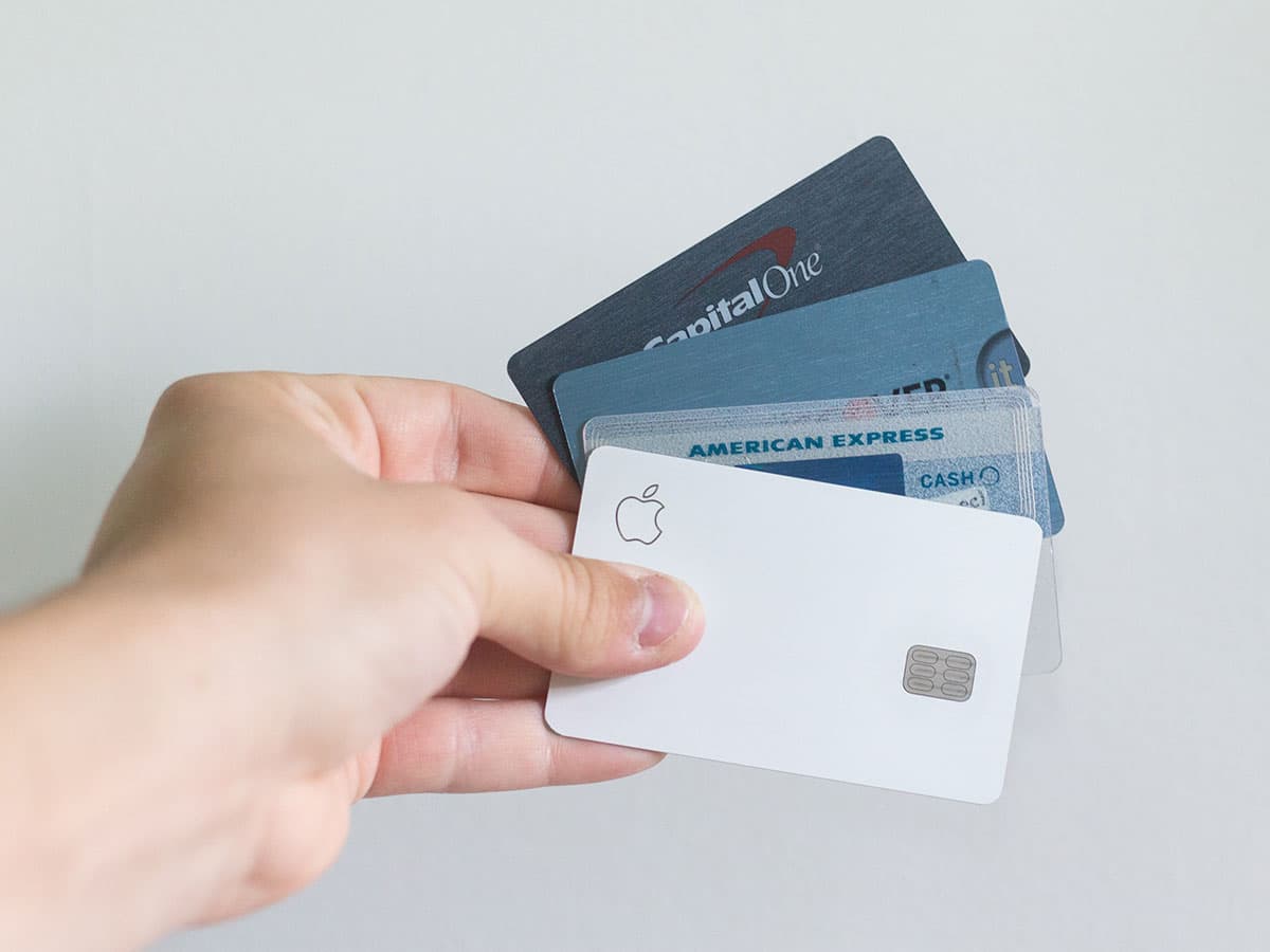 Person with multiple credit credit cards in hand wanting to aggressively pay off debt.