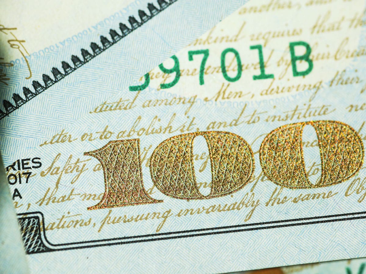 Holding a 100 dollar bill after learning how to aggressively save money.