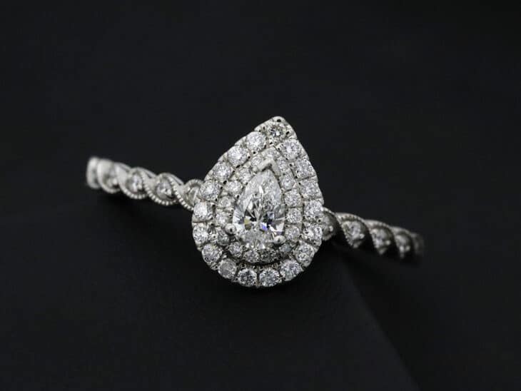 Pear-shaped diamond engagement ring with a double halo.
